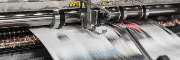 large format printing press in use. Image from unsplash.com by Bank Phrom